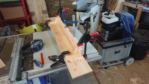 shelf and supports clamed in a really chaotic workshop