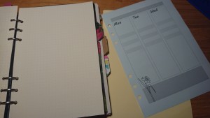 Filofax with dotted paper and homemade dividers, and week plan with columns for Mon/Tue/Wed